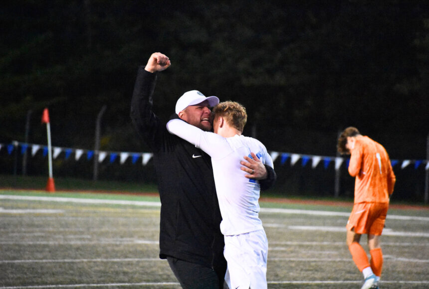 <p>Manager Joey West and Fedina celebrate the 3-2 win over Shorewood. Ben Ray / The Reporter</p>