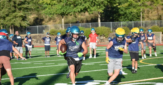 Rai Hampton runs through the Raven defense. Alexis Phung / For The Reporter