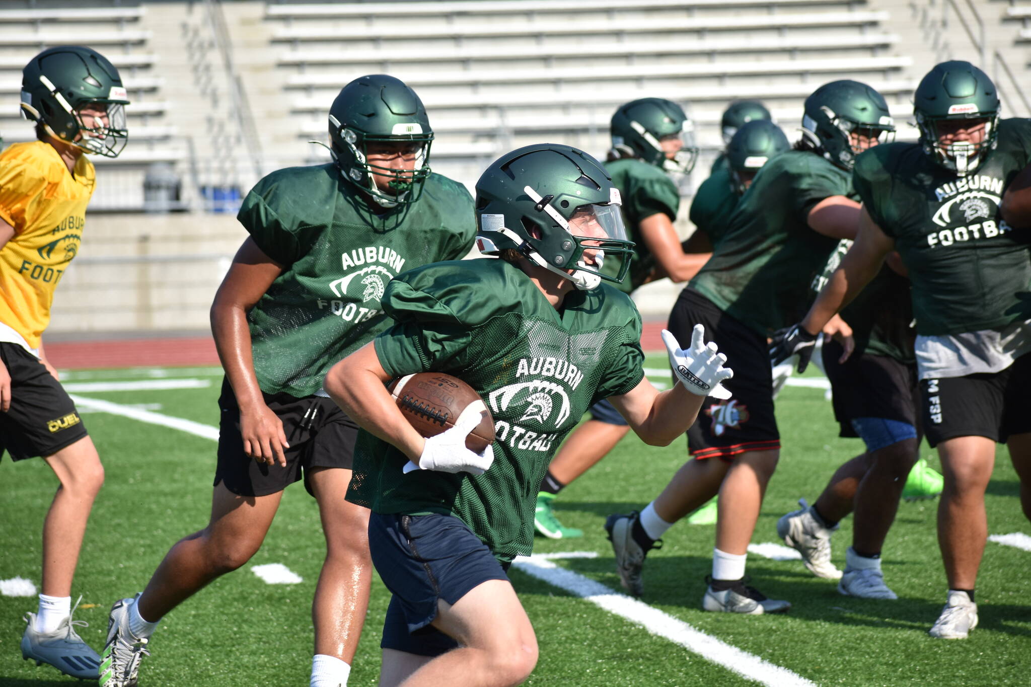 Trojan defenders chase a ball carrier at practice during a team session. Photos by Ben Ray / The Reporter