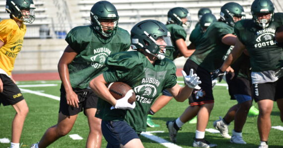 Trojan defenders chase a ball carrier at practice during a team session. Ben Ray / The Reporter