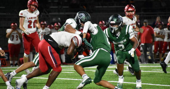 A pair of Auburn defenders tackle a Kennedy Catholic running back. Ben Ray / The Reporter