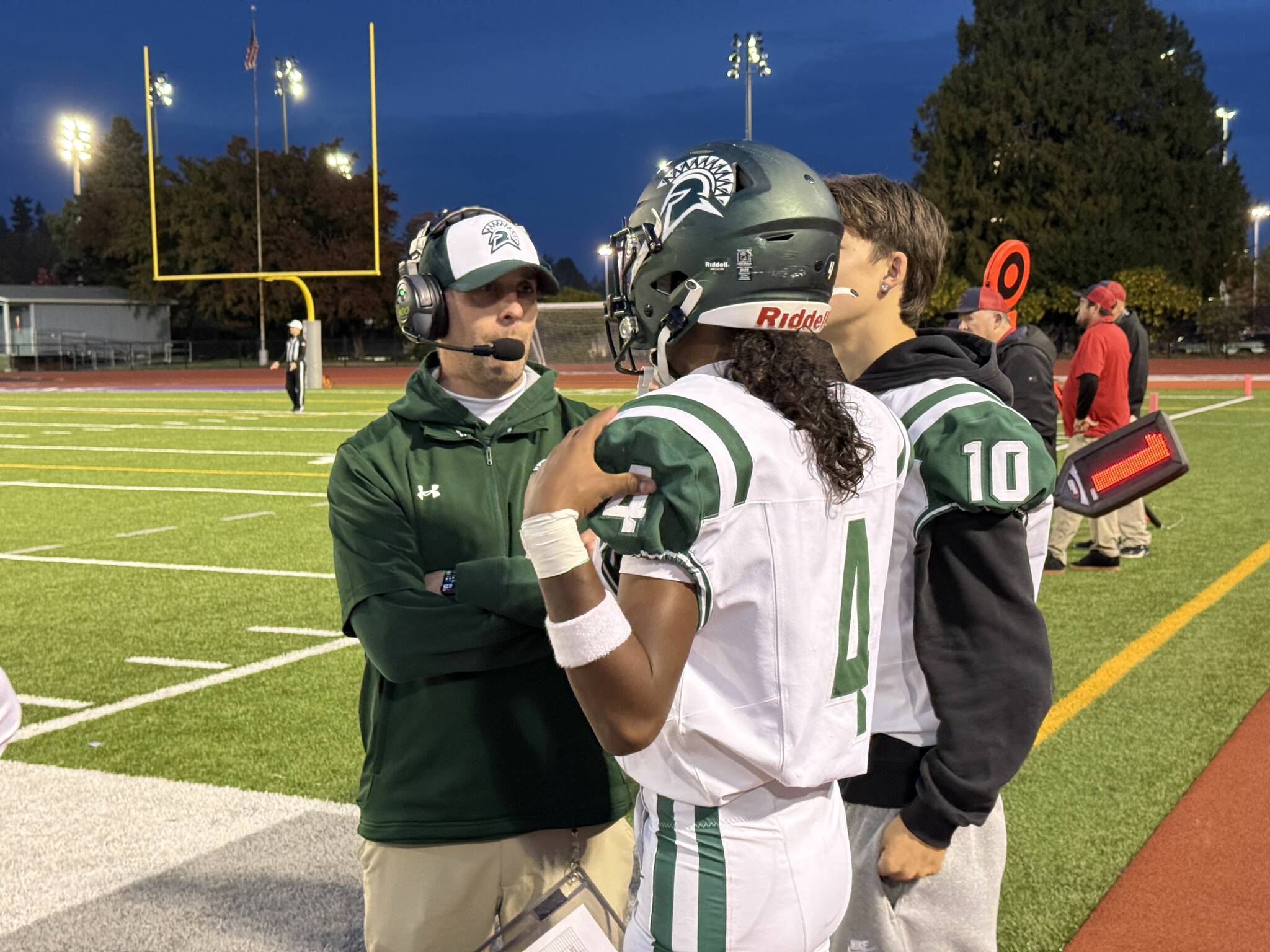 Head Coach Aaron Chantler speaks with quarterback Isaiah Avelar. Photo provided by Nathan Hyun