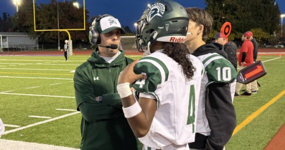 Head Coach Aaron Chantler speaks with quarterback Isaiah Avelar. Photo provided by Nathan Hyun