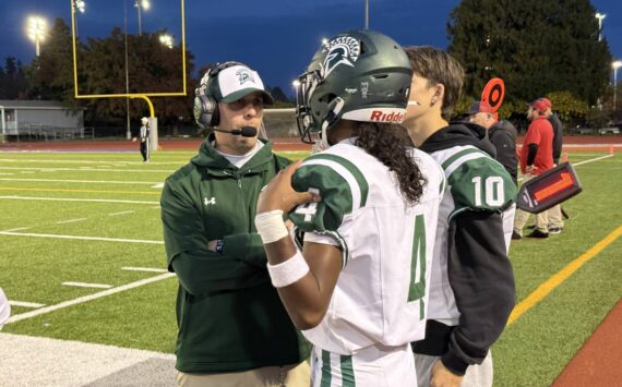 Head Coach Aaron Chantler speaks with quarterback Isaiah Avelar. Photo provided by Nathan Hyun