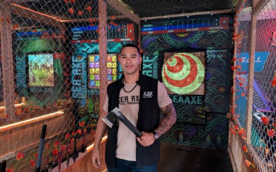 Owner Vance Olsen shows off one of Sea Axe’s throwing axes. Photo by Bailey Jo Josie/Sound Publishing