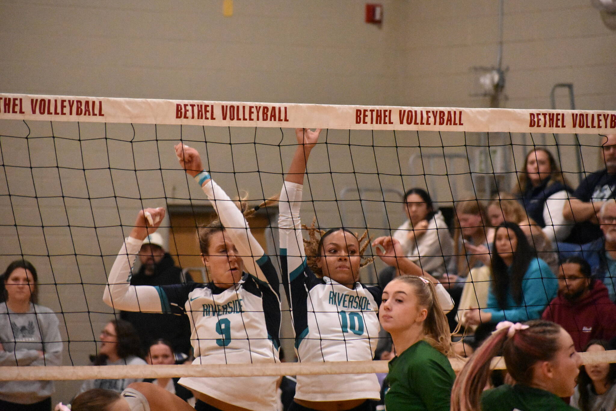 Georgia DePiano (left) and Quinci Wilder (right) come down after a block against Emerald Ridge. Ben Ray / The Reporter