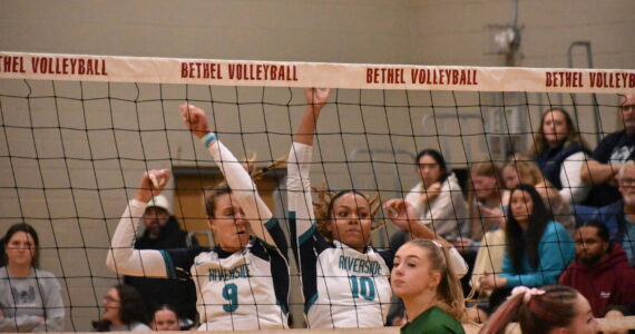 Georgia DePiano (left) and Quinci Wilder (right) come down after a block against Emerald Ridge. Ben Ray / The Reporter