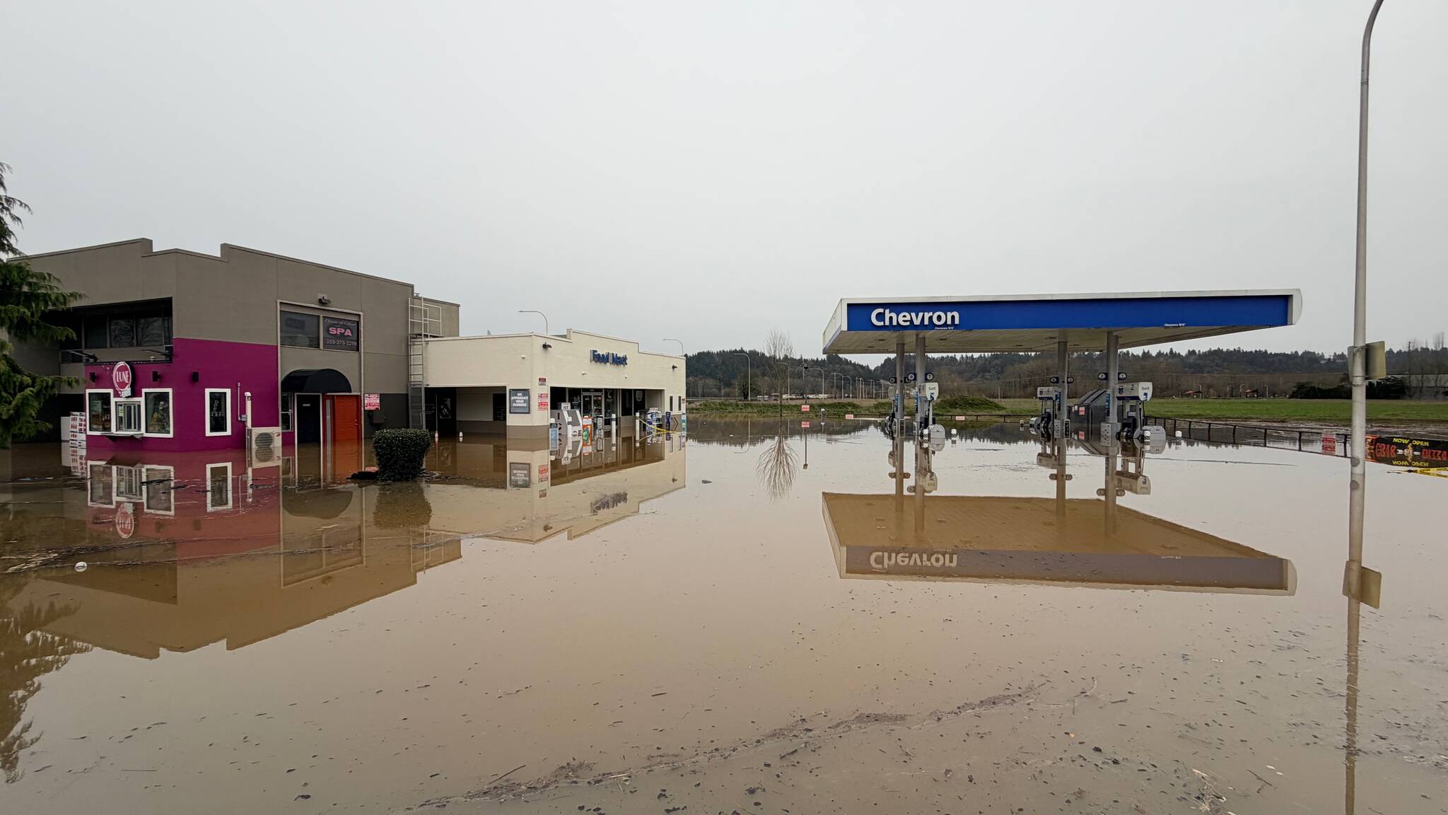 The Chevron station at 5148 Auburn Way N., Auburn, as seen on Thursday, Dec. 11. The gas station is nearly fully submerged, with gasoline mixed with water, leaving a pungent smell. Photo by Joshua Solorzano/Sound Publishing