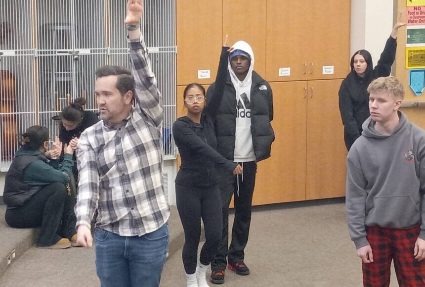 <p>Teacher Ryan Hutchison shows the Auburn High School show choir how to bust a move. Photo by Robert Whale/Auburn Reporter</p>