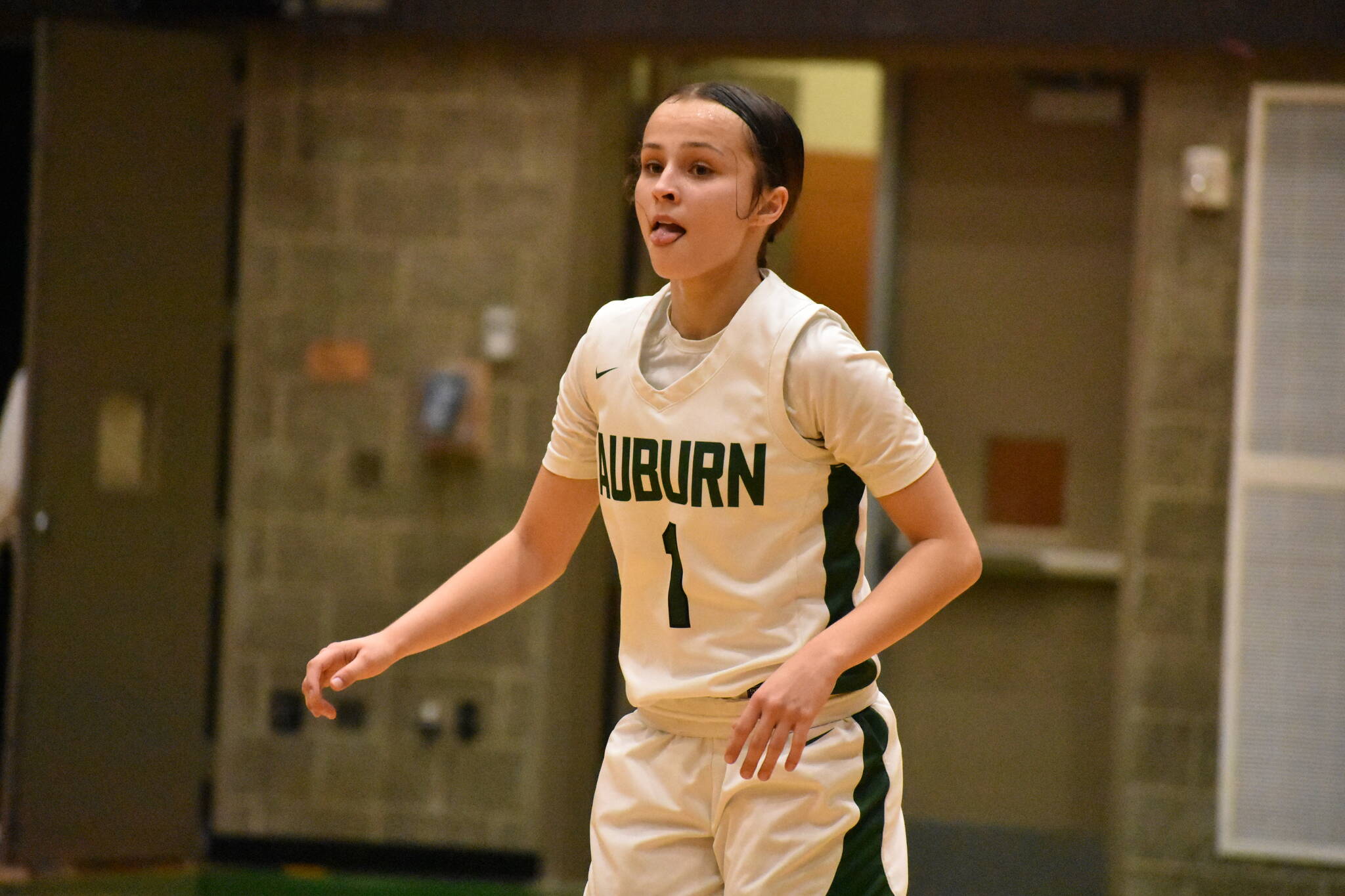 Jordyn Schoenbachler sticks her tongue out after making a three for Auburn. Ben Ray / The Reporter
