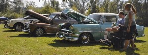 Susan Douglas and Terry Norman gaze at a lineup of classic cars at the annual Show and Shine at Pacific City Park last Saturday. All types of cars