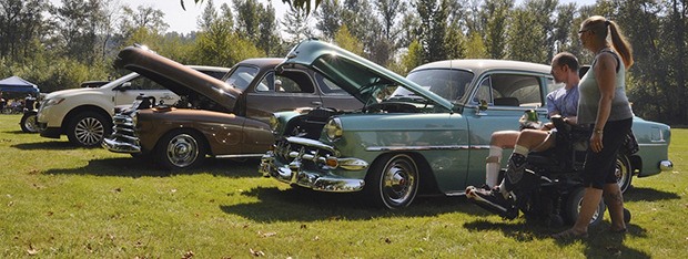Susan Douglas and Terry Norman gaze at a lineup of classic cars at the annual Show and Shine at Pacific City Park last Saturday. All types of cars