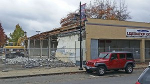 Crews begin to demolish the old Liquidation Outlet! building