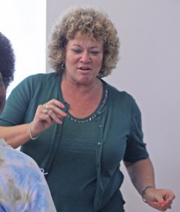 Mayor Nancy Backus joins students from the Neighborhood House Tutoring Program in a dance during a Cultural Day event at the Firwood Circle Community Center on Aug