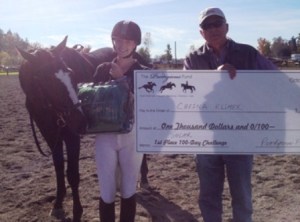 Jack Hodge presents Solar and trainer/rider Chesna Klimek with $1