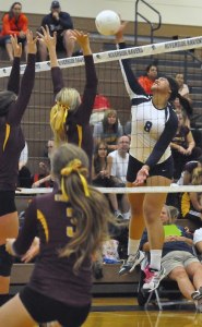 Auburn Riverside's Precious Atafua spikes the ball in a match against Enumclaw on Tuesday.