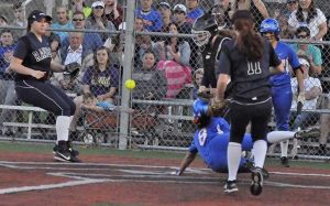 Auburn Mountainview's Zoe Collins avoids a tag at home plate during the Lions' 3-2 win Thursday against Auburn Riverside in a South Puget Sound League 3A fastpitch contest.
