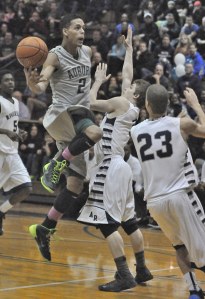 Auburn's Marquise Prater elevates for a shot over Raven players  Mitch Wetmore and Earl Taylor Jr.