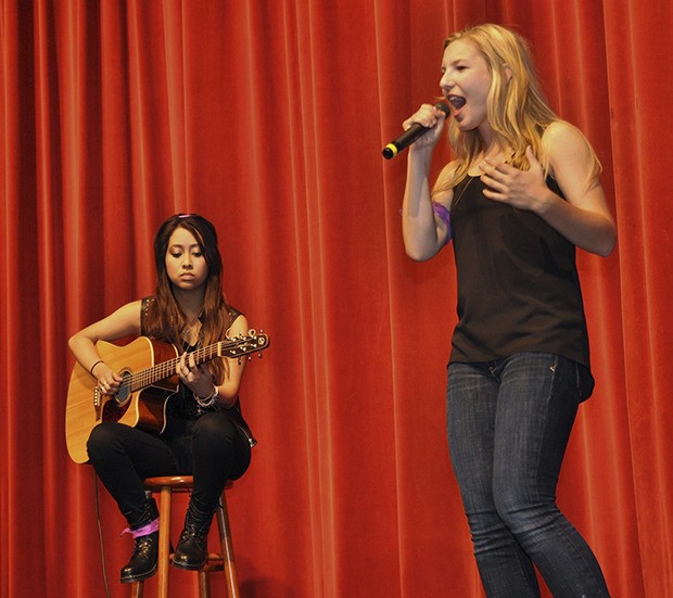 Auburn Mountainview's Morgan Nyren sings with Bella Farinas on the guitar at the benefit concert.
