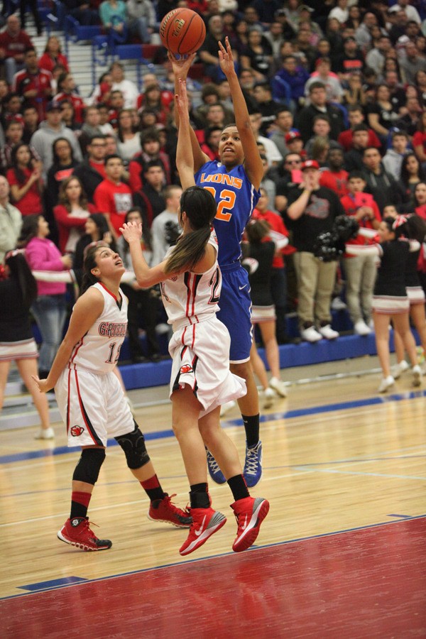 Senior Maddie Taylor takes a shot over a pair of Sunnyside defenders.