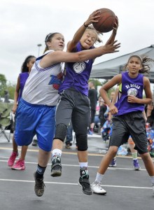 Kaia Stansberry on D1 Bound grabs a rebound against the Tune Squad during seventh-grade girls action at the Jim Marsh Classic last Sunday at Emerald Downs. The classic