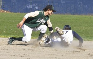 Auburn's Xavier West puts a tag on an Auburn Riverside runner.
