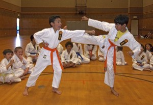 Students at the Unified Karate School in Auburn practice sparring.