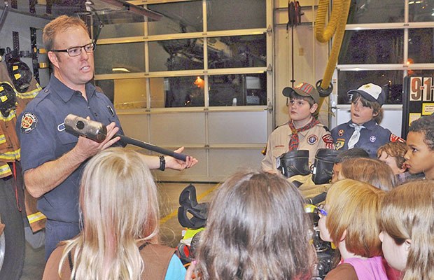Valley Regional Fire Authority Firefighter Dean McAuley talks to Boy and Girl Scouts about his profession and the equipment it requires during the recent Scout Night at the Fire Station. Scouts toured Fire Station 34 on Auburn’s Lea Hill and were taught fire safety practices