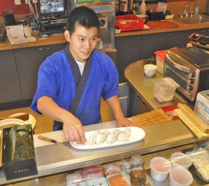 Alexander Park prepares a sushi roll at Flying Fish