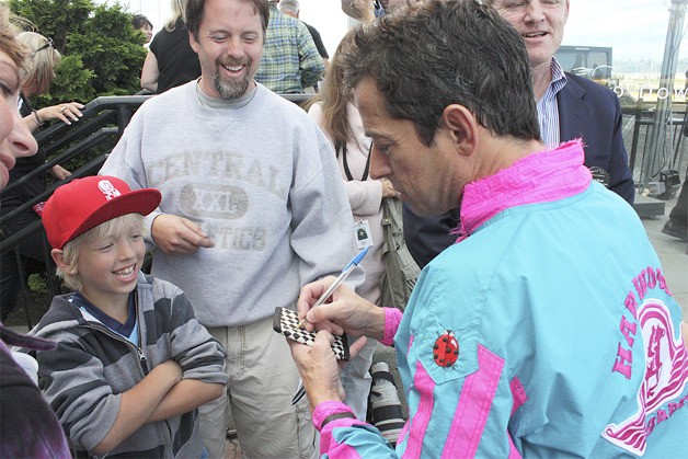 Jockey Ricky Frazier signs an autograph after guiding Noosa Beach to victory in the Longacres Mile at Emerald Downs last Sunday.
