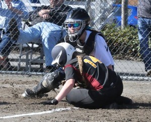 Auburn Riverside catch Alli Hand tags out Enumclaw's Cyarah Sell at home.