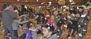 Kids and families frolic in make-believe snow on Frosty Family Fun Night in the Evergreen Heights Elementary School gymnasium Thursday.