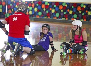 Christopher Bower (back to camera) gives some advice to fledgling derby-ite Payton Krier