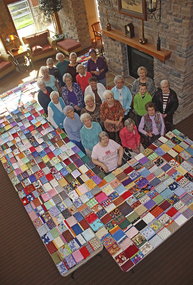 Volunteers display the record 444th pillowcase they stitched for the Auburn Valley YMCA drive for Mary Bridge Children’s Hospital