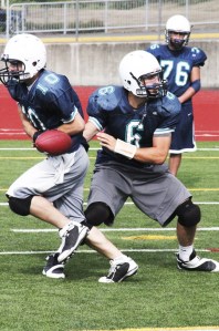 Auburn Riverside senior quarterback Josh Latta prepares for the Ravens opener against Kentlake.