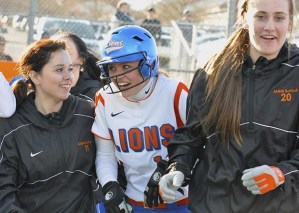 Sam Slagle celebrates her home run with teammates.