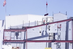 A construction crew scales beams in the 82-degree heat Tuesday afternoon as work continues on the construction of the new Auburn High School. According to school officials