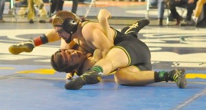 Auburn's James West manhandles South Kitsap's Michael Beard.