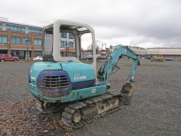 The first earth moving equipment arrived this week at the future site of the 5-story Trek Apartments project between South Division and A Street Southeast