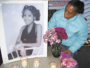 Rhonda White turns to look at a portrait of her daughter