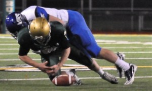 Auburn's Tarin McDonald fumbles after being crushed by Curtis defensive back Rahmel Dockery.
