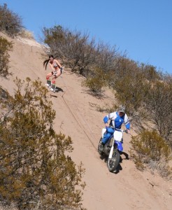With her father pulling her behind a dirt bike