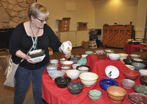 Debbie Keeley shops for a bowl during last year's benefit. The special luncheon returns Friday at Grace Community Church.