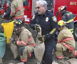 Pacific Police Lt. Edwin Massey and firefighters fill sandbags at Monday’s Take Winter By Storm emergency preparedness event in Pacific.
