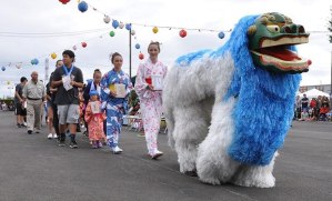 The Shinshi Mai Lion Dog leads the Children’s Parade at the Bon Odori Festival on Saturday.