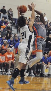 Auburn Mountainview’s Ki’Jan Weisinger attempts a shot against the tight defense of  Auburn Riverside’s Julian Gulchuk during South Puget Sound League 3A play Tuesday night.  The Lions prevailed