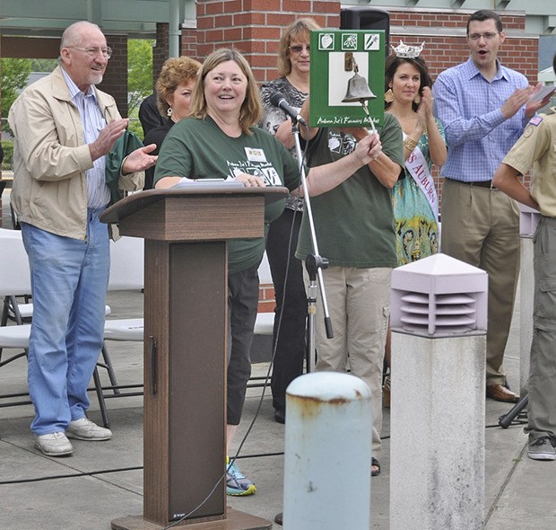 Auburn International Farmers Market Manager Joanne Macnab rings the bell to officially begin the new season last Sunday. The market is open each Sunday through Sept. 21.