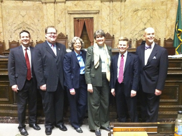 The six openly-gay members of the Washington State House of Representatives gather for a picture on the floor of the House chambers following passage of the marriage equality bill Wednesday. From left: Dave Upthegrove (D-33rd)