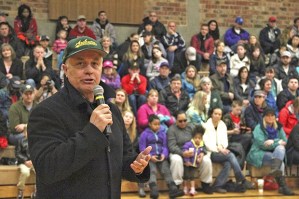 Auburn School District Superintendent Kip Herren addresses the crowd during the Auburn Little League opening ceremonies on Saturday.