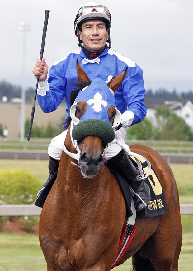 Javier Matias is all smiles after guiding Fleur De Lis Stables Winning Machine to a victory in the 2012 Budweiser Handicap at Emerald Downs. The two veterans